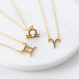 Image shows a selection of gold micro pave rainbow zodiac necklace