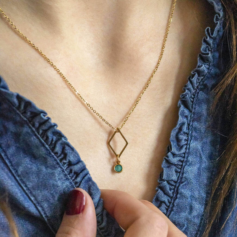 Image shows model wearing minimalist gold rhombus birthstone charm necklace