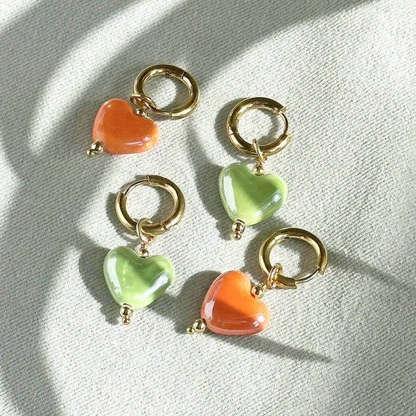 Images shows green and orange Mix and Match Glazed Heart Huggie Hoop Earrings