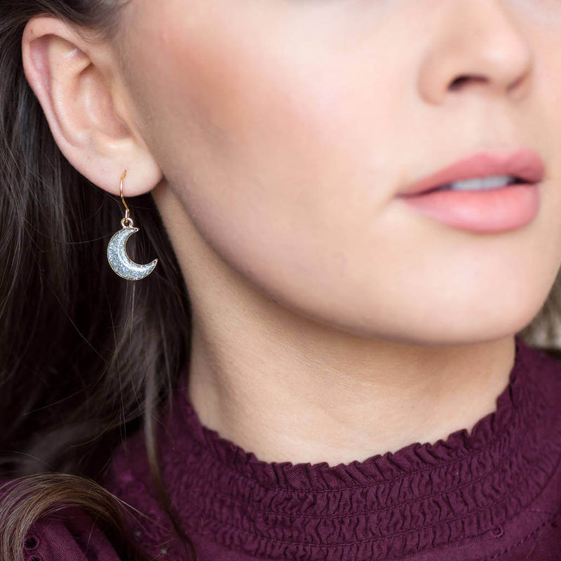 Image shows model wearing Moon Sparkle Earring 