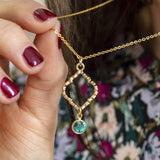 Image shows model holding Moroccan Inspired Necklace with Birthstone Detail