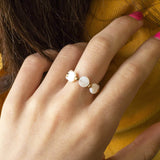 Model wears mother of pearl disc stretch ring