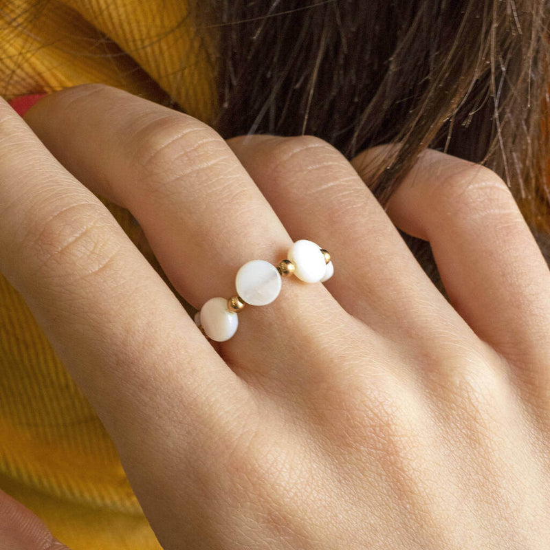  Model wears mother of pearl disc stretch ring