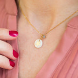 Model wears mother of pearl star necklace with April(crystal) birthstone detail