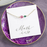 Image shows Mother and Child Beaded Birthstone Chain Bracelet on a Mum sentiment card sitting in a purple trinket dish