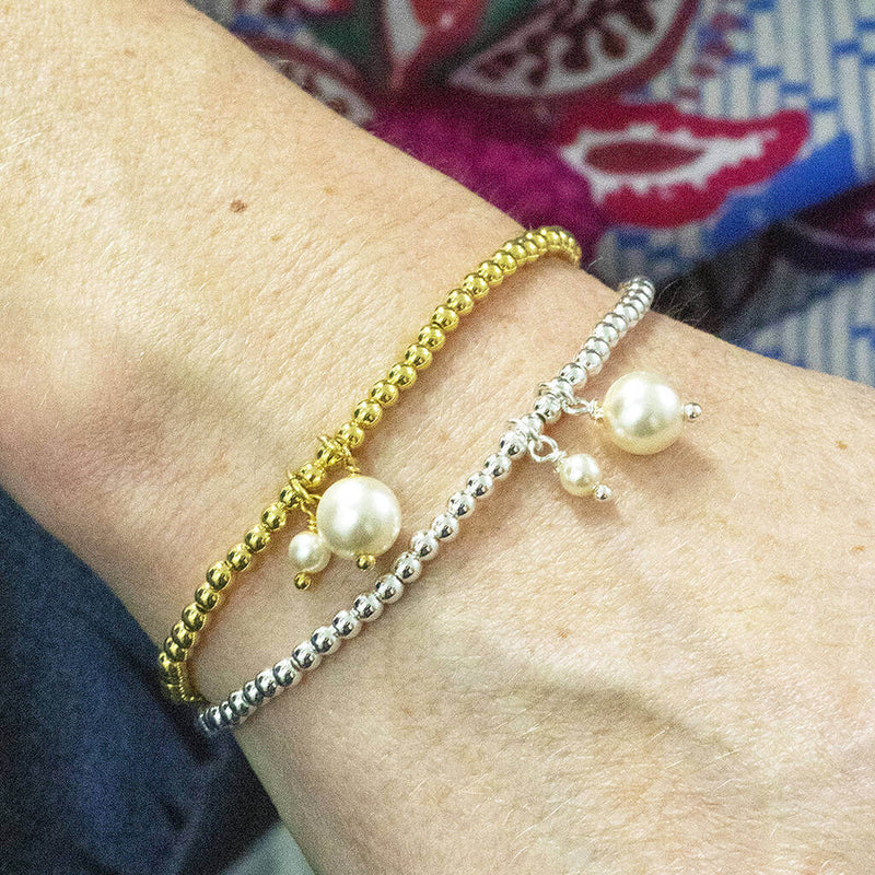 images shows model wearing mother and child pearl bracelet.