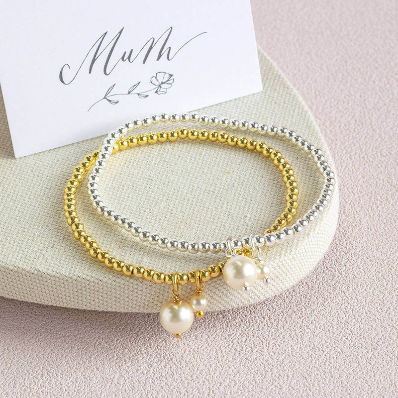Image show a gold and silver mother and child pearl bracelet next to a mum sentiment card.