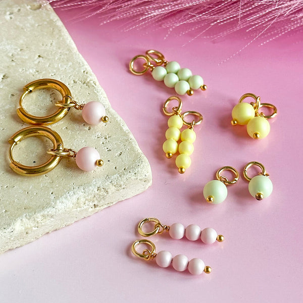 Image shows Multi Charm Pastel Pearl Hoop Earrings
