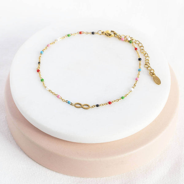 Image shows dainty multicoloured beaded infinity anklet on a white backdrop.