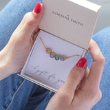  Image shows model holding  personalised enamel disc name necklace  with the name Cara in a gift box on the A gift for you sentiment card