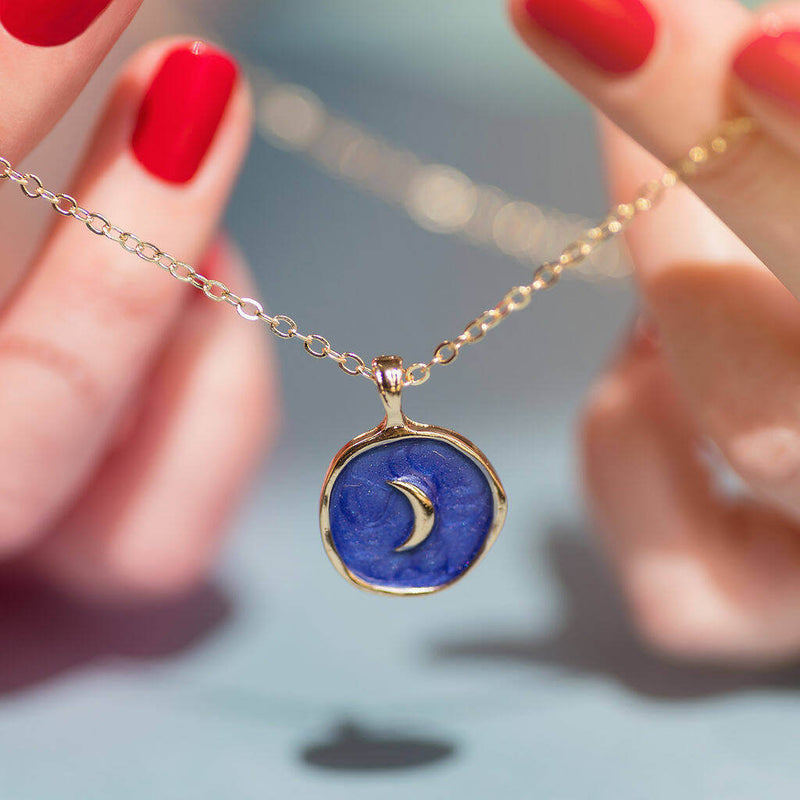 Image shows model holding Organic Circle Blue Moon Necklace