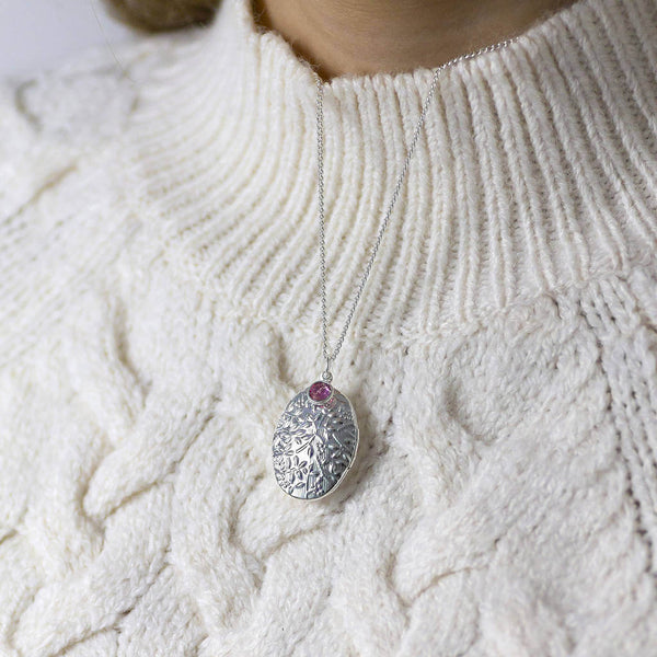 Image shows model wearing Oversized Oval Birthstone Locket Necklace with October birthstone