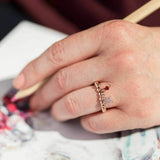 Image shows model wearing rose gold pave star beaded charm ring with Janurary birthstone