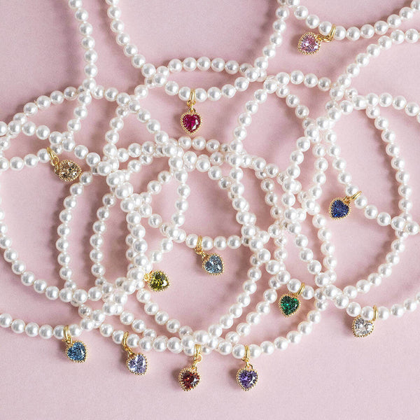 Image shows a selection of Pearl Bracelet with Heart Birthstone Charm