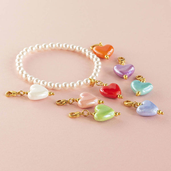 Image shows pearl stretch bracelet with mix and match heart charms