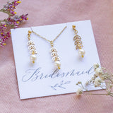 Pearl leaf chain bridesmaid jewellery gift set on bridesmaid sentiment card lying on pink cord with white and pink and yellow dried flowers either side