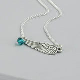 Image shows personalised angel wing necklace with December birthstone