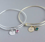 Image shows silver and gold personalised birthstone bangles