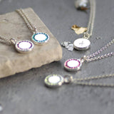 Image shows a selection of personalised birthstone disc pendant necklaces