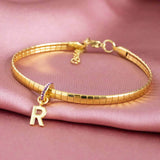 Image shows personalised birthstone ring initial bracelet with the initial R and February birthstone