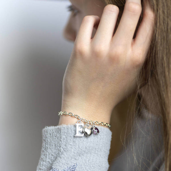 Image shows model wearing personalised Childs charm bracelet