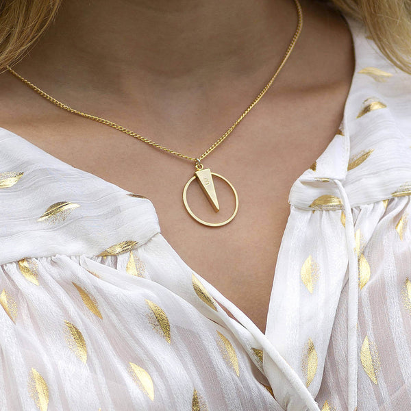 Image shows model wearing gold personalised circle spike necklace engraved with the letter B