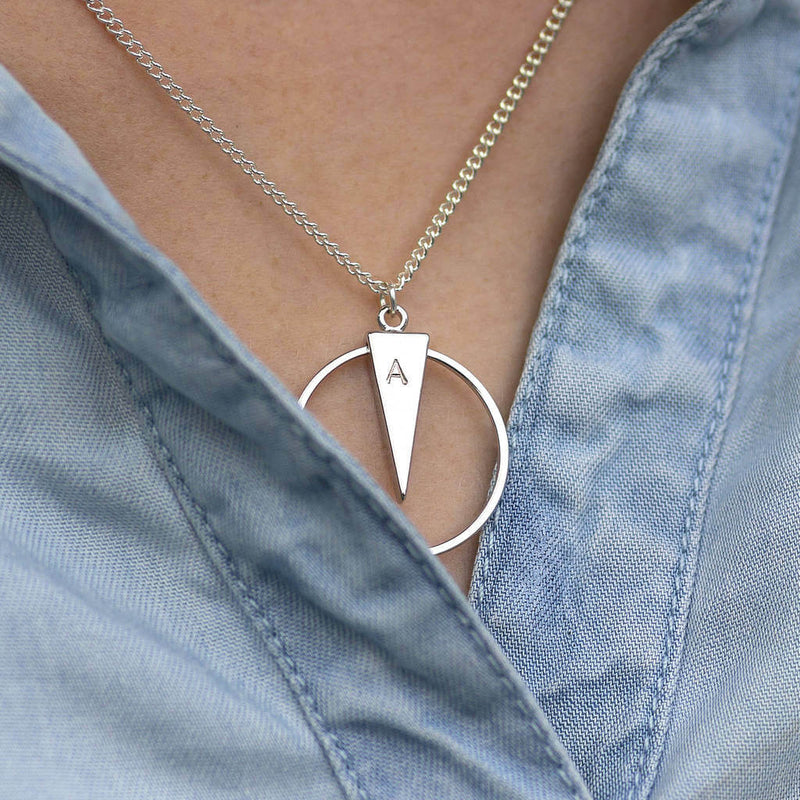 Image shows model wearing silverpersonalised circle spike necklace engraved with the letter A