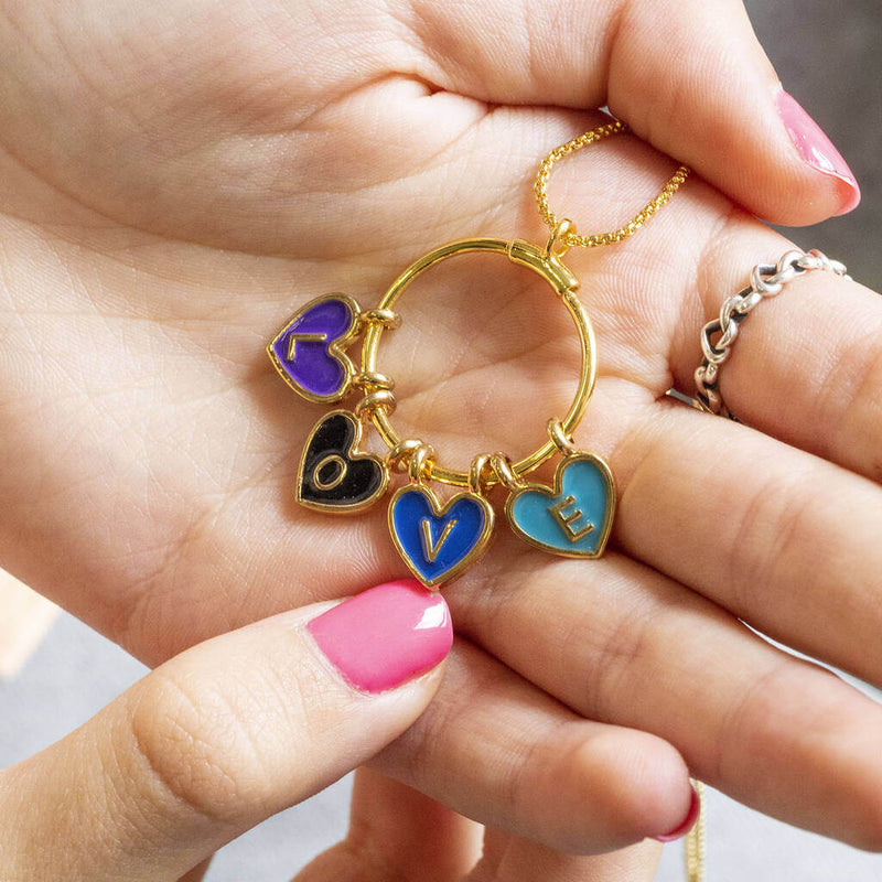 Image shows model holding Personalised Enamel Heart Name or Word Story Necklace with the word LOVE