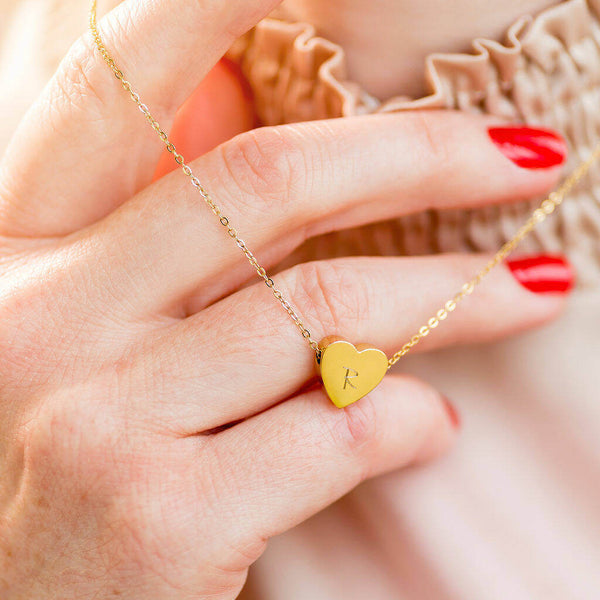 Image shows model holding personalised floating heart necklace
