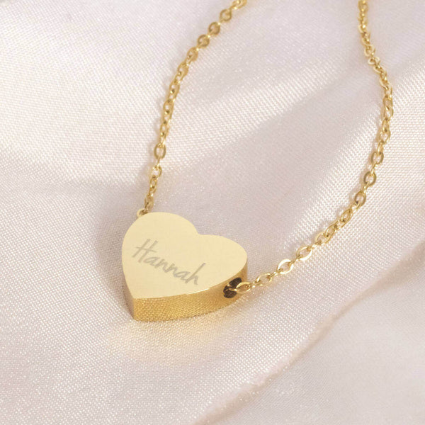 Image shows personalised floating heart necklace engraved with the name Hannah
