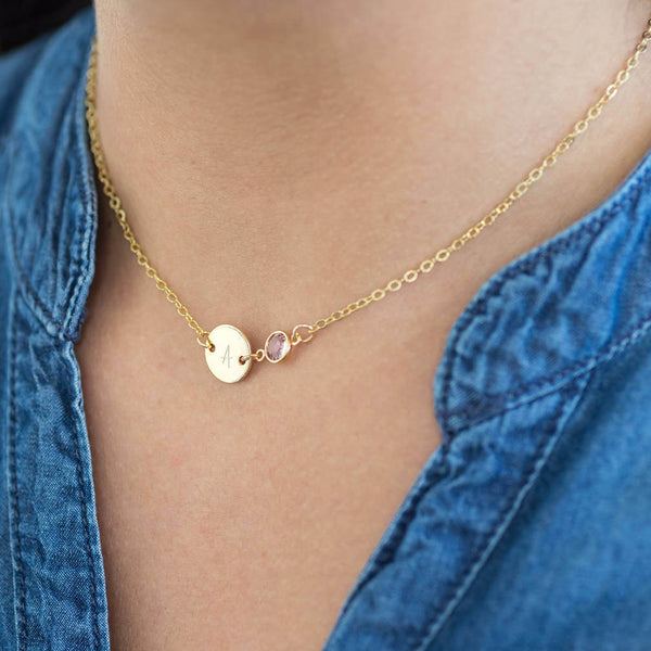 Image shows model wearing personalised gold disc birthstone necklace with Ai initial on disc and  June birthstone