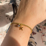 Image shows model wearing personalised gold  plated beaded birthstone bracelet with K initial and  March birthstone