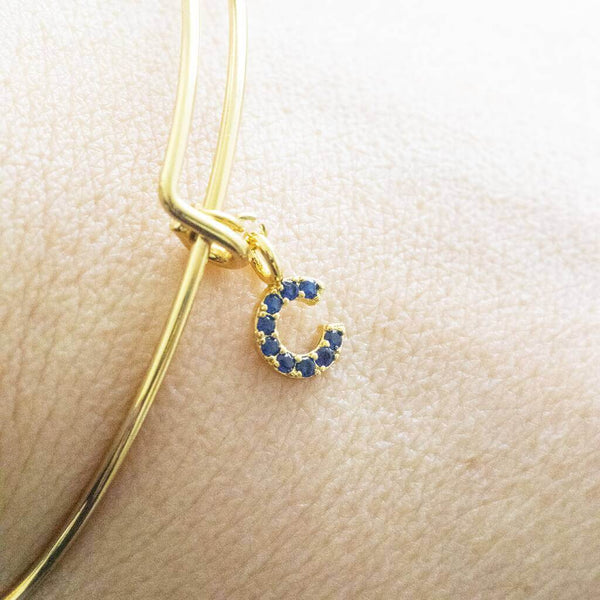 Image shows model wearing Personalised Gold  Birthstone Initial Bangle
