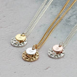 Images shows three hammered disc necklace silver with gold initial disc A, gold with silver disc with heart and Silver with rose gold disc with initial B 