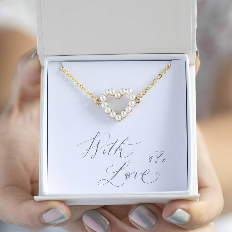 Image shows model holding  Personalised Heart Bracelet with Pearl Detail in gift box on a with love sentiment card