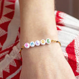 Image shows model wearing personalised name enamel chain bracelet with the name  Chloe