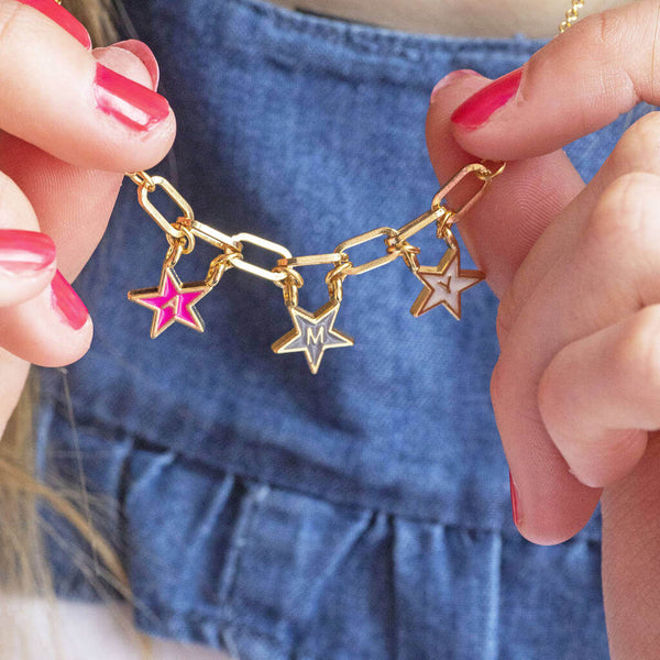 Image shows model wearing personalised name in stars enamel necklace with the name AMY