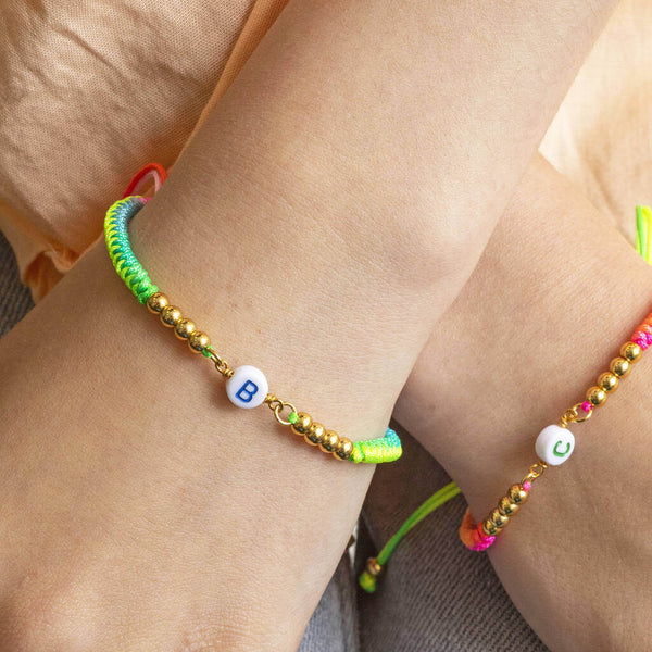 Image shows model wearing Personalised Neon Friendship Bracelets on each wrist