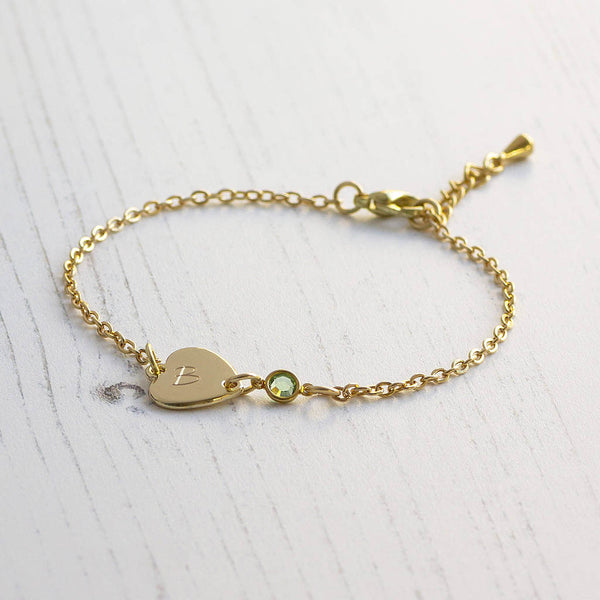 Image shows personalised sideways heart birthstone bracelet engraved with the letter B and March birthstone