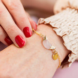 Image shows model wearing personalised  rose quartz half moon bracelet