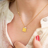Image shows model wearing personalised square charm necklace
