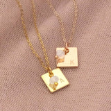 Image shows a gold and rose gold personalised square charm necklace