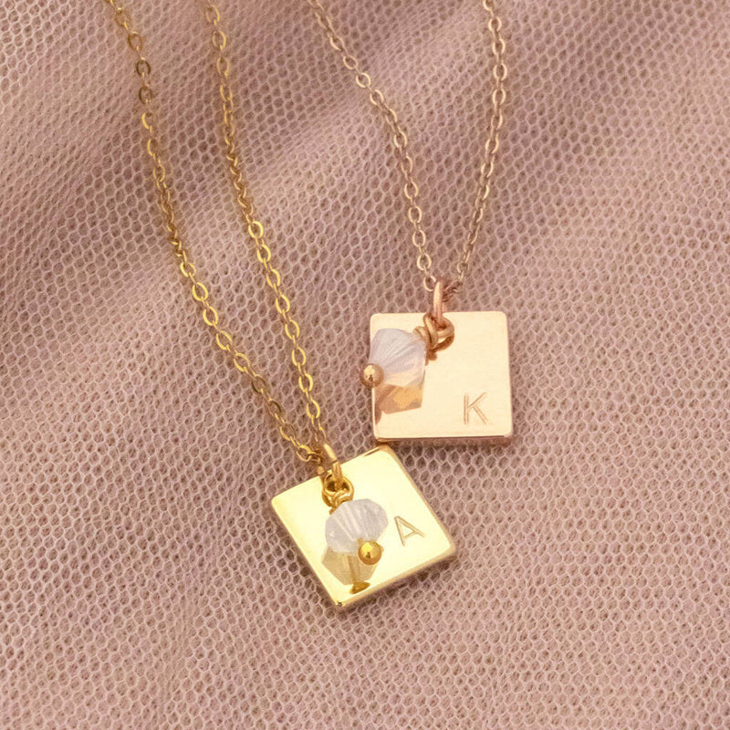 Image shows a gold and rose gold personalised square charm necklace