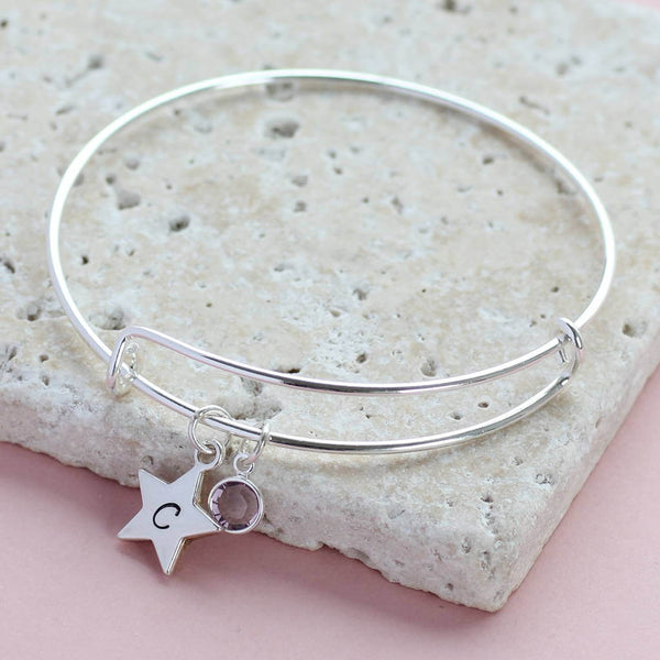Image shows personalised star birthstone bangle with  initial C on the star and  June birthstone