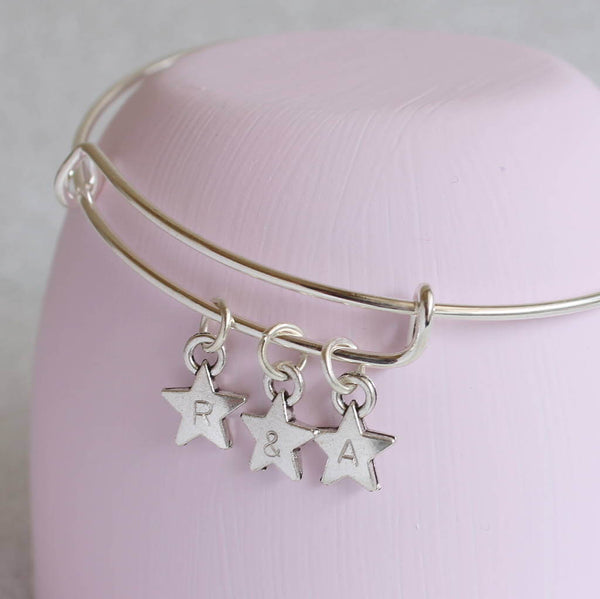 Image shows personalised stars charm bangle with 3 star charms