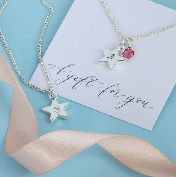 Image shows two personalised star charm necklaces