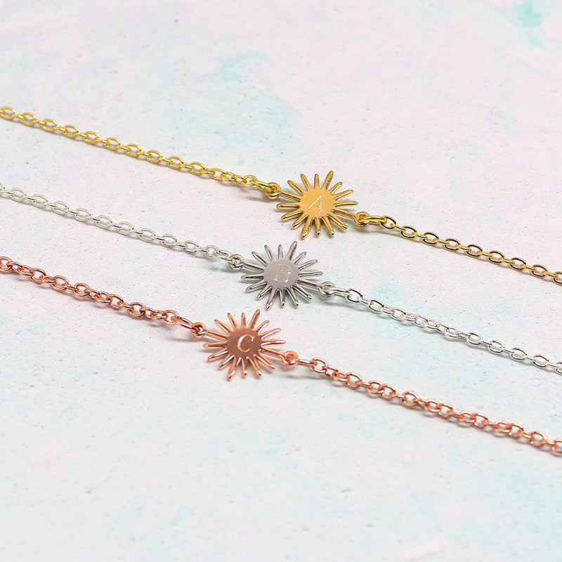 Image shows three personalised sunburst bracelets gold, silver and rose gold