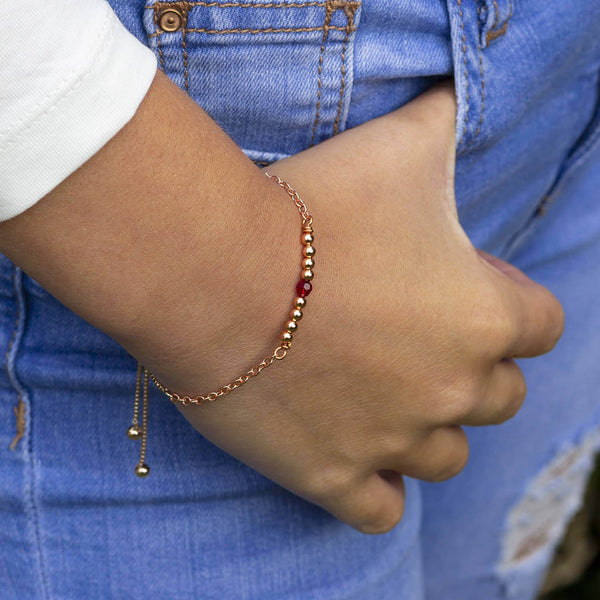 Image shows model wearing Rose Gold Birthstone Bar Slider Bracelet