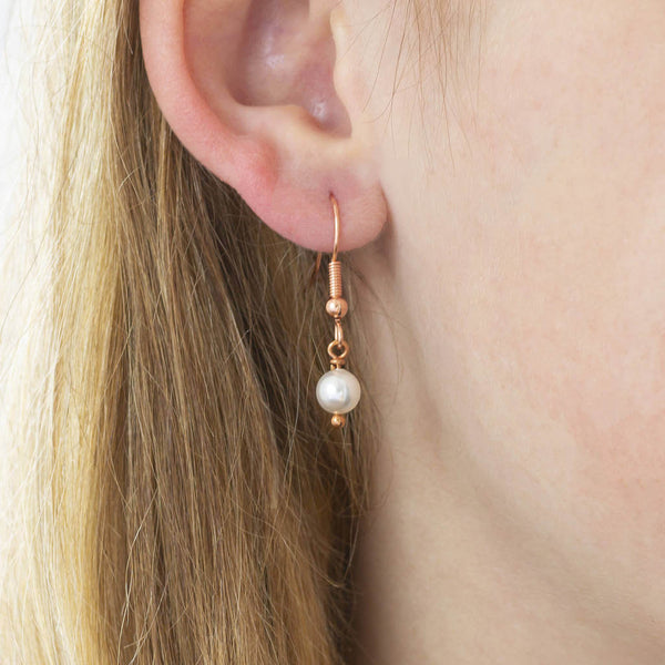 Image shows model wearing Rose Gold Swarovski Pearl Earring