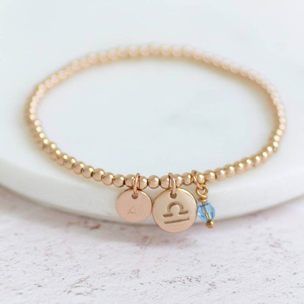 Image shows Rose Gold Zodiac Beaded Charm Bracelet with March birthstone